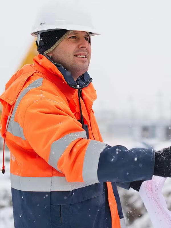 Outdoor worker wearing an orange high visibility jacket